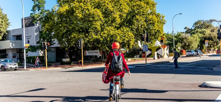 Person riding bike over road