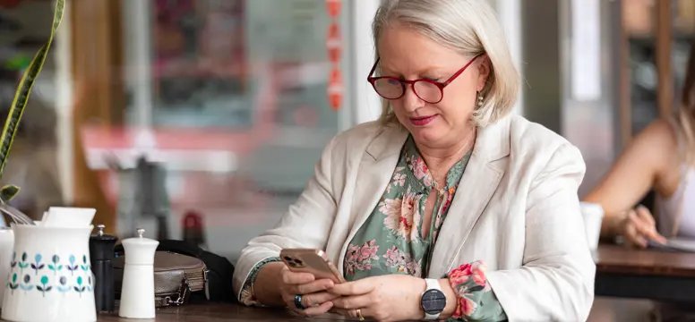 Lady at cafe on phone Architects and Heroes (2)