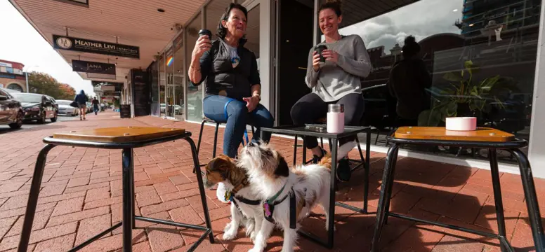 People sitting at cafe with dog
