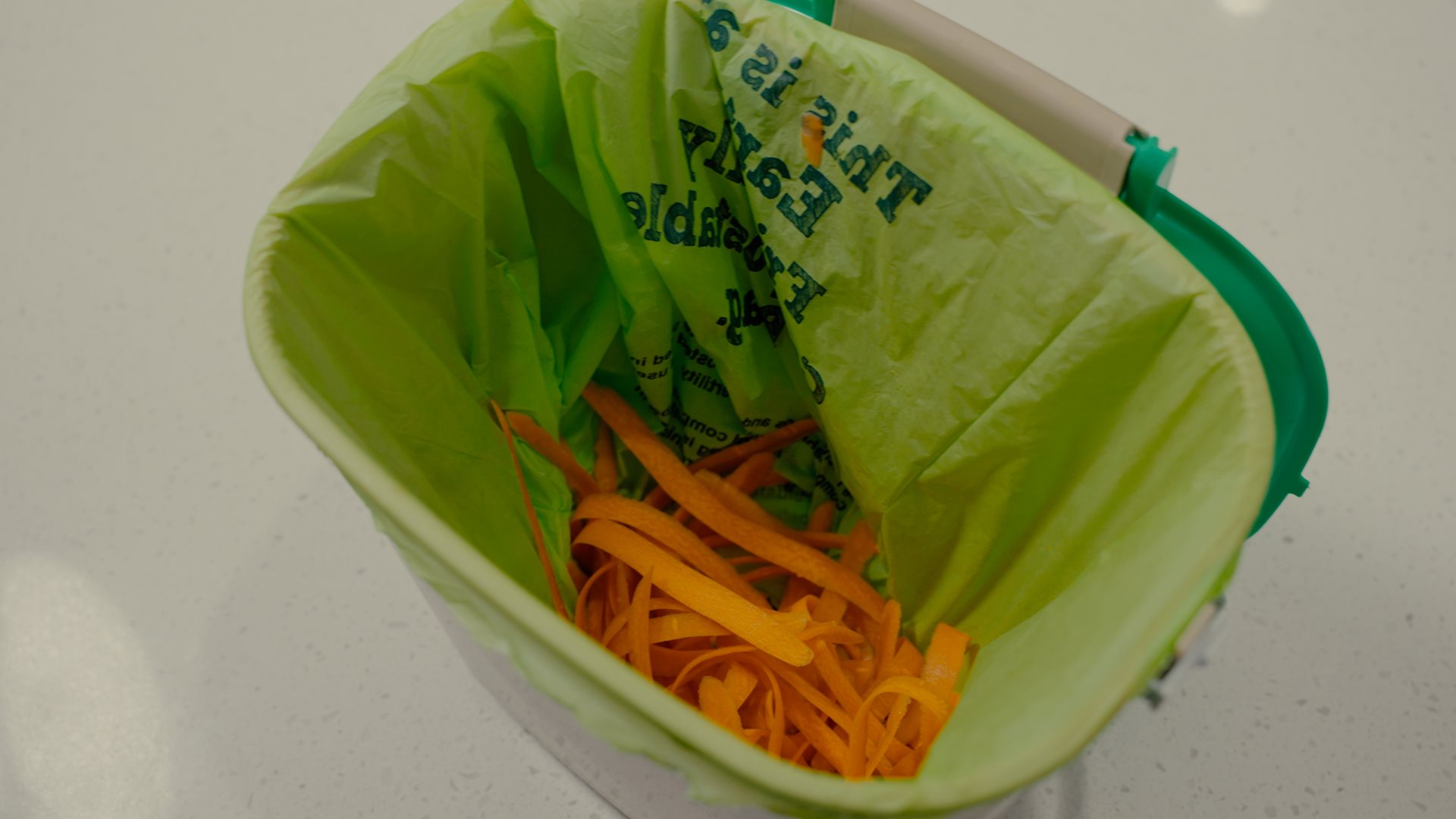 Carrot scraps in a kitchen caddy