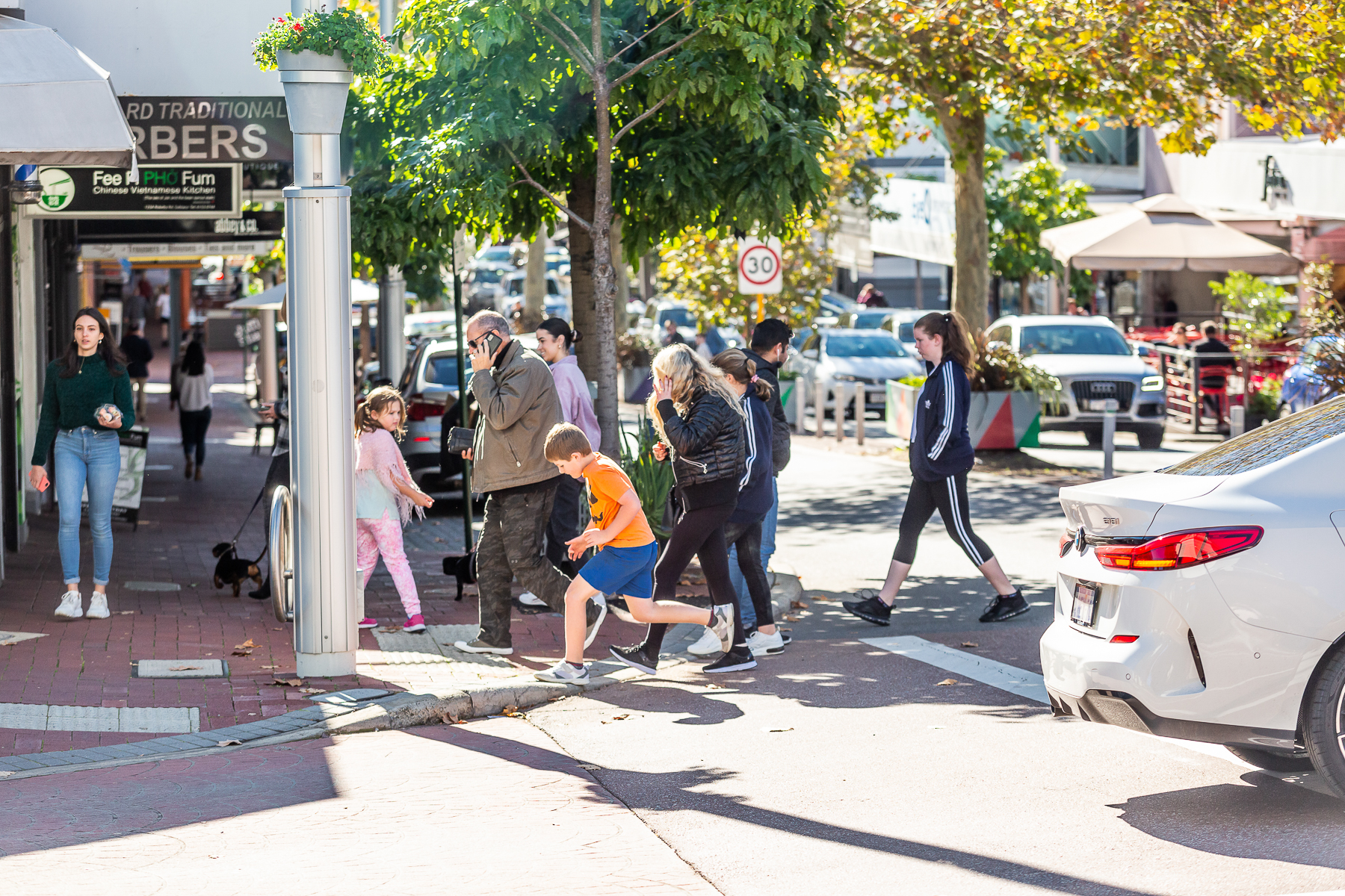 People of different ages crossing busy road