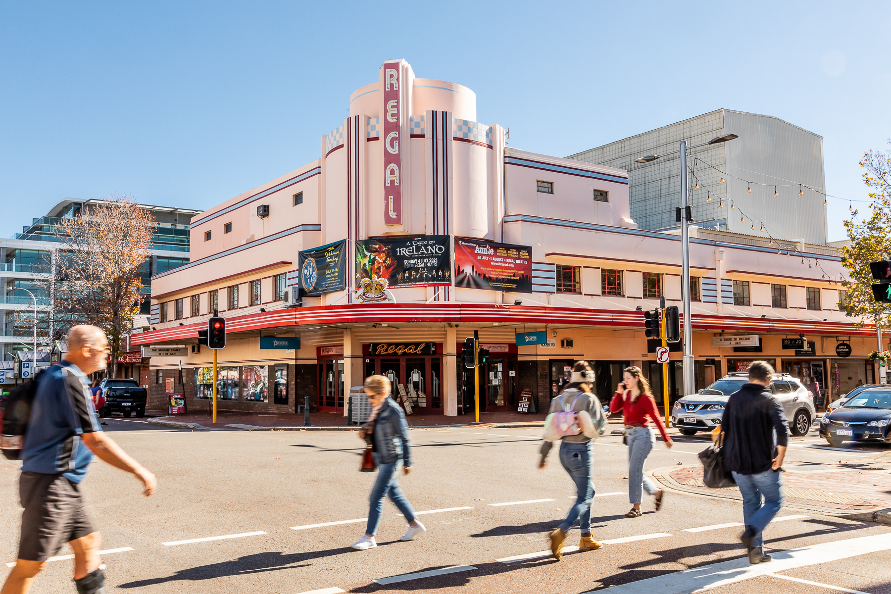 People walking in front of Regal Theatre