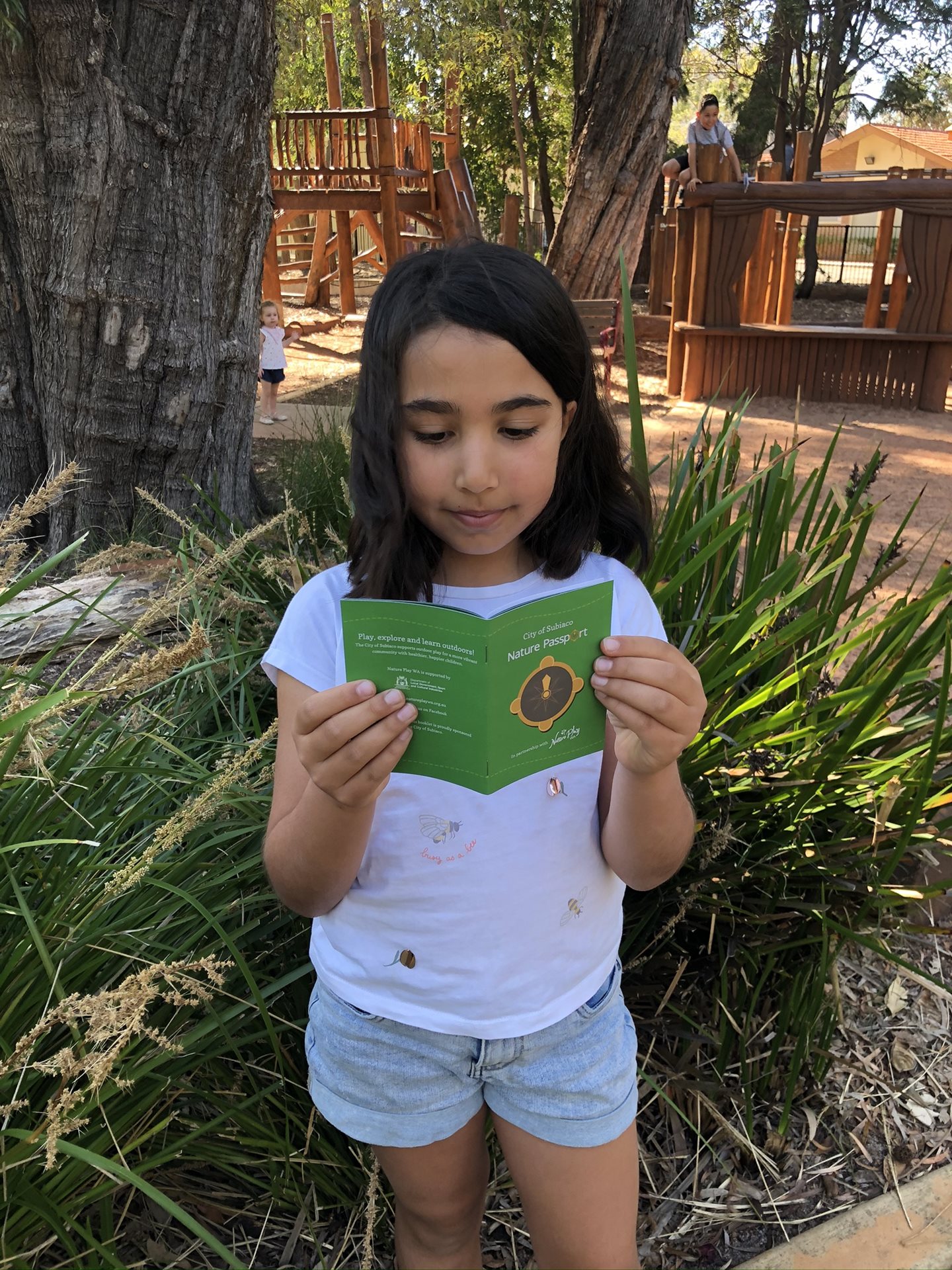Girl reading Nature Passport booklet