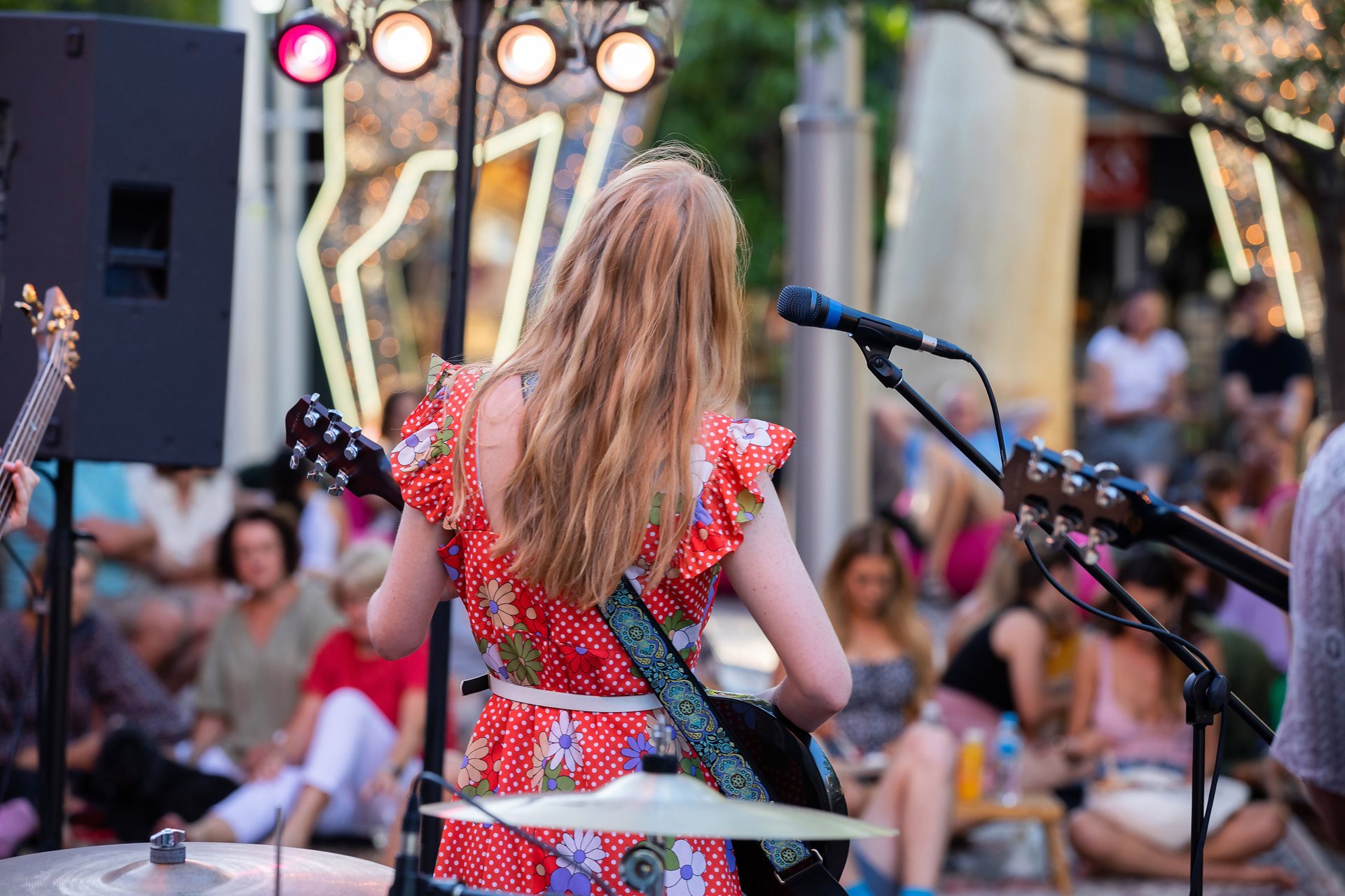 A musician plays for a crowd of onlookers