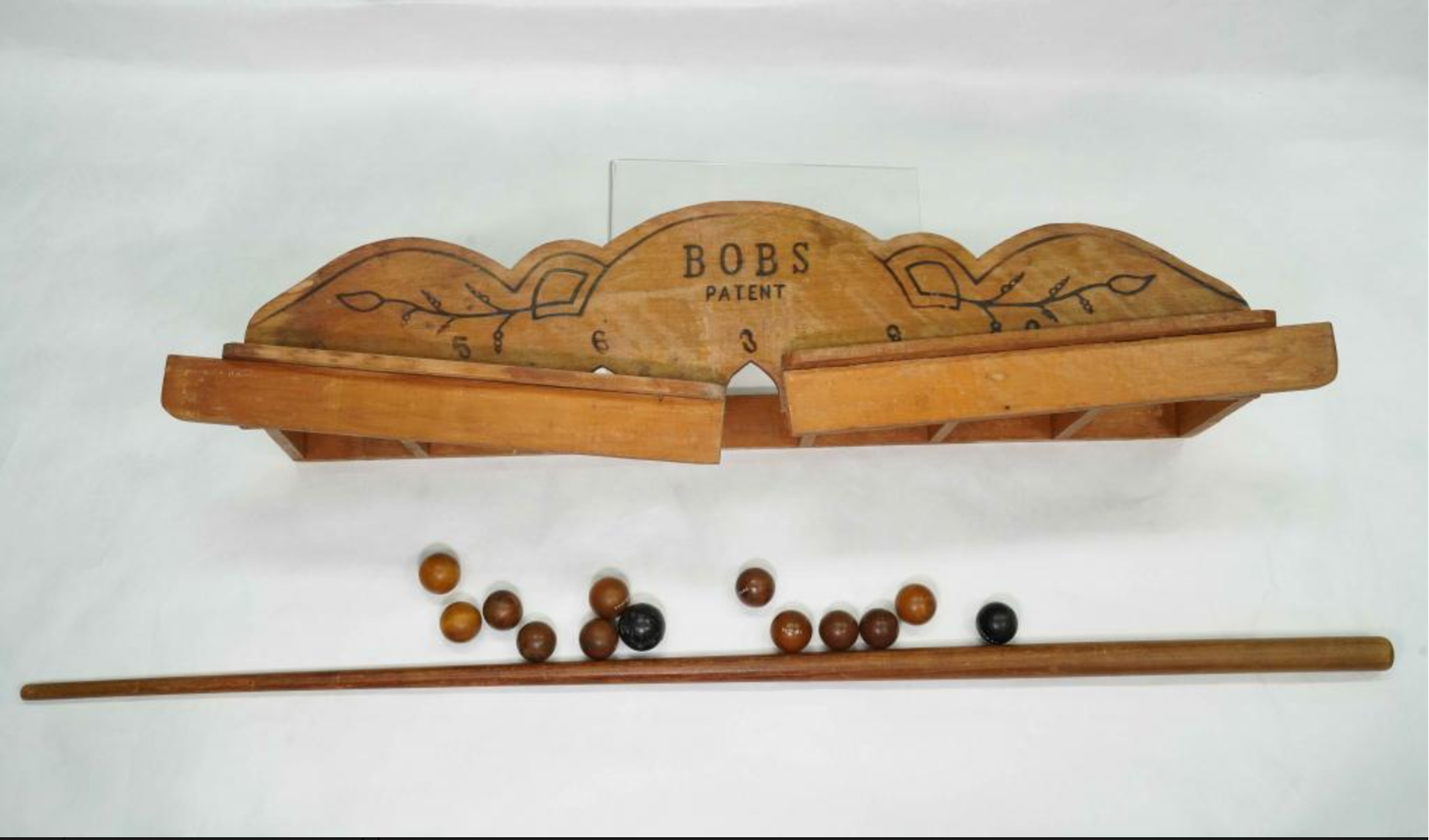 Wooden tabletop game called Bobs set consisting of balls and a cue