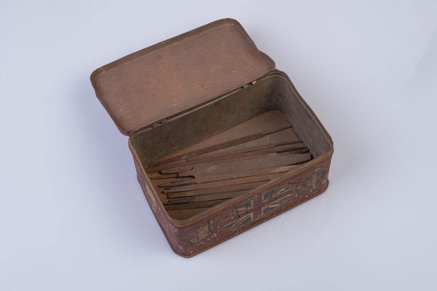 Tin box full of metal files open 