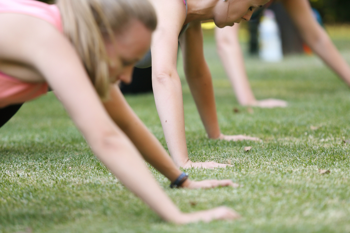 People doing push ups in the park